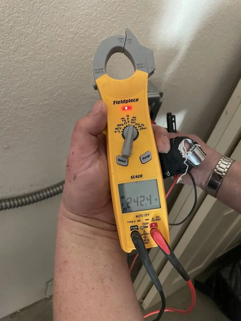 Voltage testing with clamp meter during Recessed Lighting Installation in North Fayette